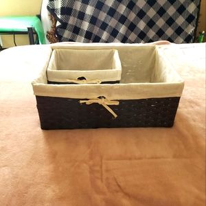 Two dark brown weaving baskets with crochet hooks